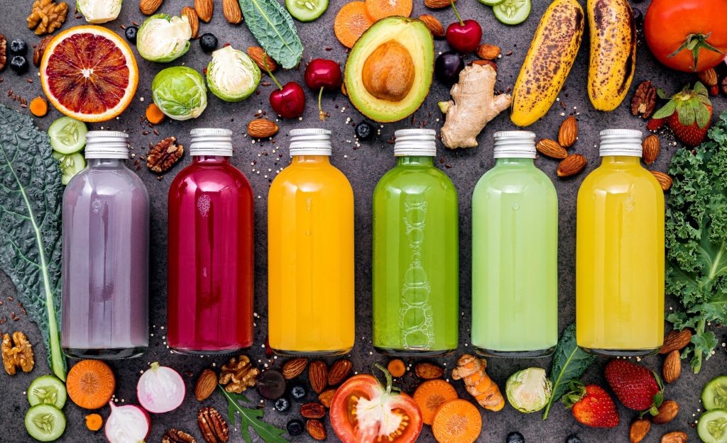 colorful healthy smoothies juices bottles with fresh tropical fruit superfoods dark stoneHHHHHH